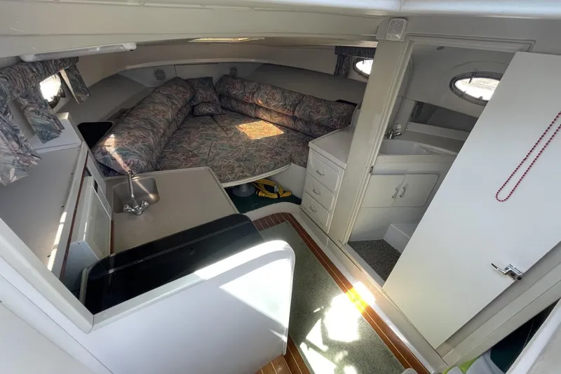 Slide: The Image of 1997 Stamas 310 Express cabin interior with kitchenette, bed, and storage. - 26