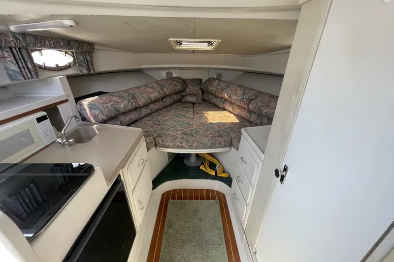Slide: The Image of Interior of 1997 Stamas 310 Express boat with kitchenette and cozy seating area. - 27