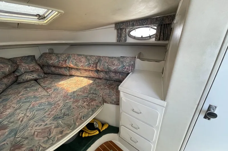 Slide: The Image of 1997 Stamas 310 Express cabin interior with patterned cushions and storage drawers. - 30