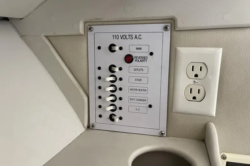 Slide: The Image of Control panel and outlet on 1997 Stamas 310 Express boat, featuring switches for various functions. - 31