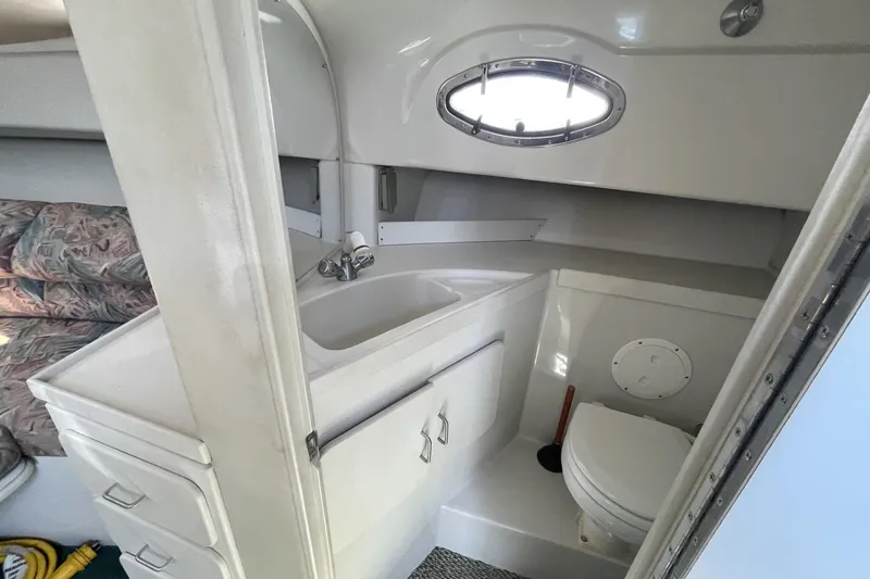 Slide: The Image of 1997 Stamas 310 Express boat interior bathroom with sink and toilet. - 34