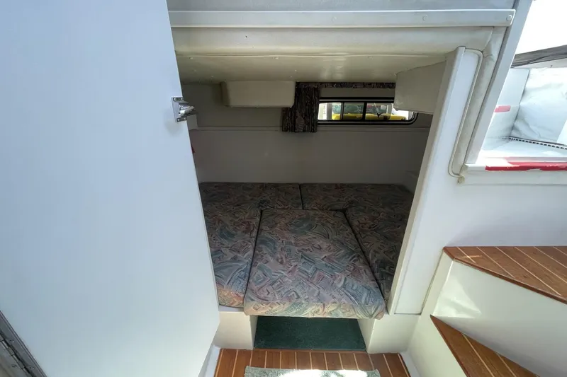 Slide: The Image of 1997 Stamas 310 Express cabin interior with patterned bedding and wooden steps. - 35