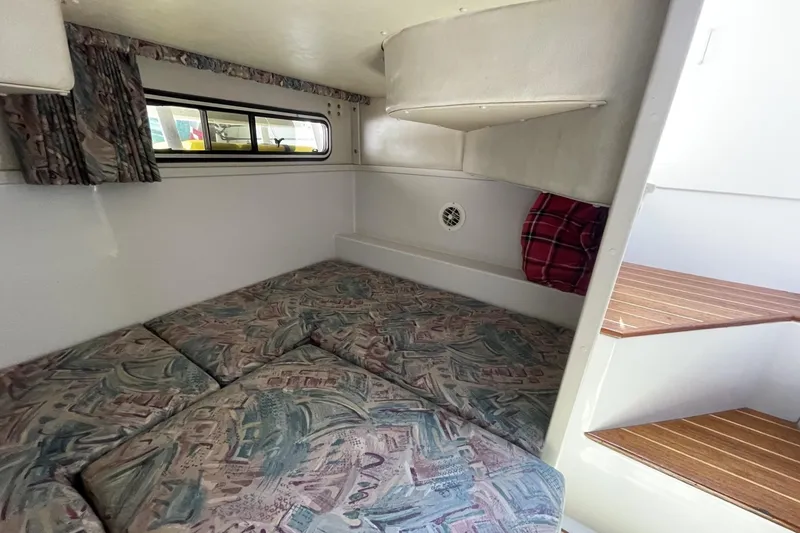 Slide: The Image of 1997 Stamas 310 Express cabin interior with patterned cushions and wooden steps. - 37