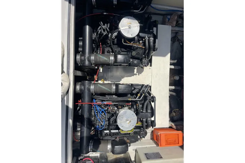 Slide: The Image of Engine compartment of a 1997 Stamas 310 Express boat, showcasing dual engines. - 38