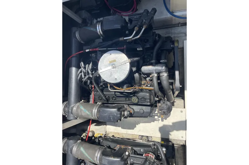 Slide: The Image of Engine compartment of a 1997 Stamas 310 Express boat, showcasing mechanical components. - 41