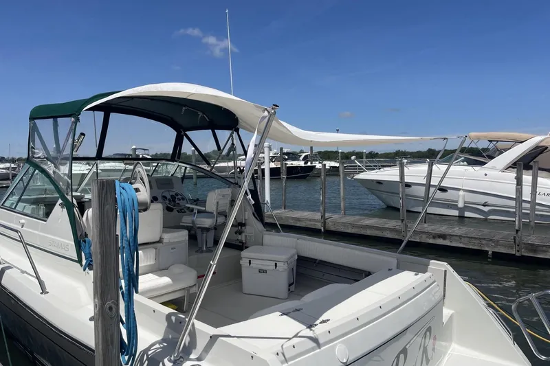 Slide: The Image of 1997 Stamas 310 Express boat docked at marina under clear blue sky. - 42