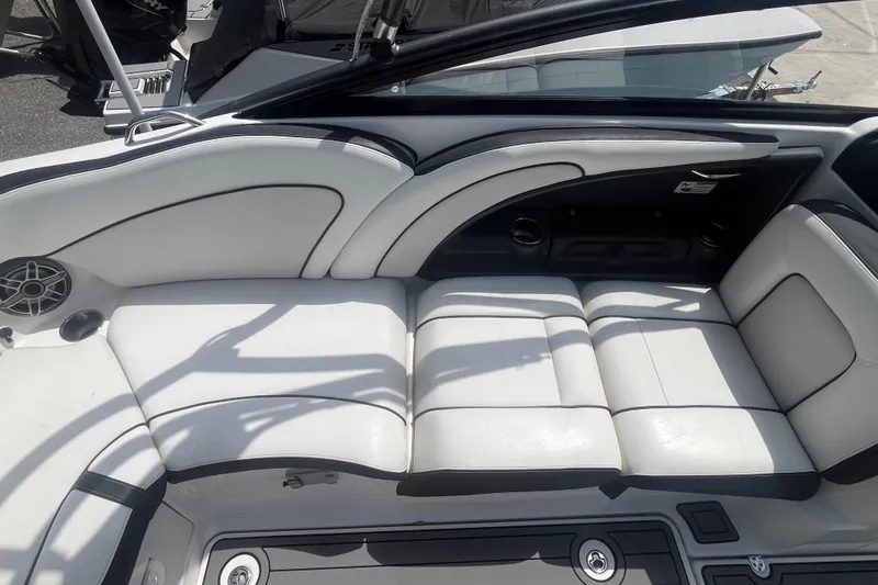 Slide: The Image of 2014 Yamaha Boats AR240 HO interior with white cushioned seating and sleek design. - 11