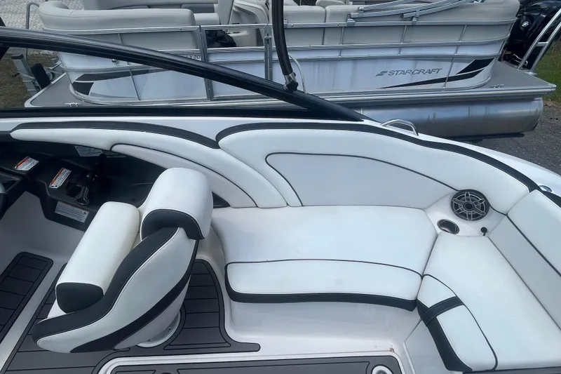 Slide: The Image of 2014 Yamaha Boats AR240 HO interior with white seating and sleek design. - 14