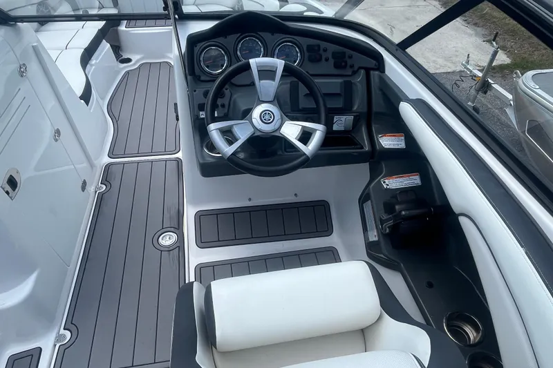 Slide: The Image of 2014 Yamaha Boats AR240 HO cockpit with steering wheel and dashboard controls. - 15