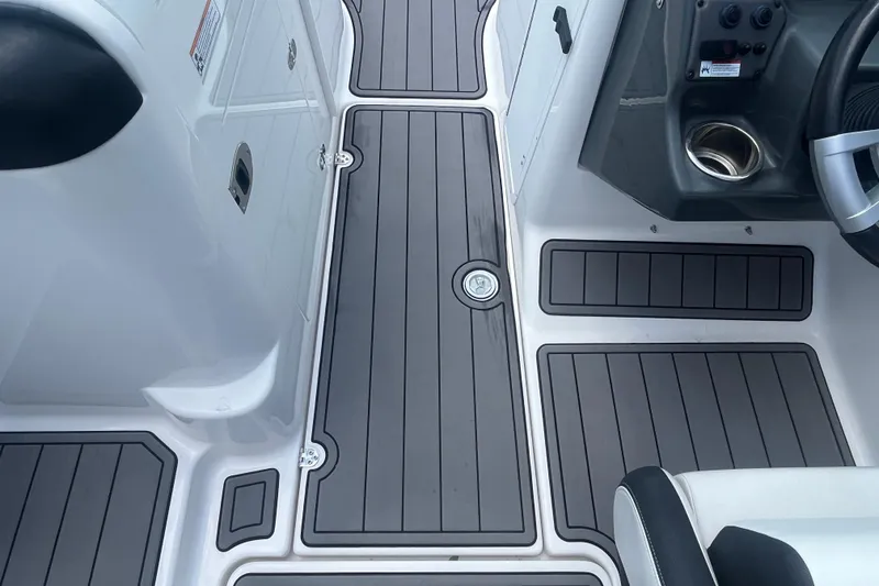 Slide: The Image of 2014 Yamaha Boats AR240 HO interior with sleek, modern deck design and steering console. - 18