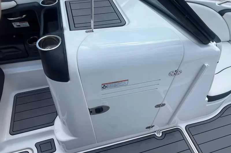 Slide: The Image of 2014 Yamaha Boats AR240 HO interior with cup holders and storage compartment. - 19