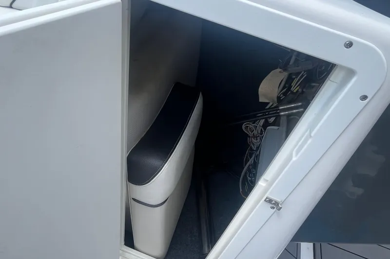 Slide: The Image of 2014 Yamaha Boats AR240 HO interior storage compartment with seat and equipment. - 21