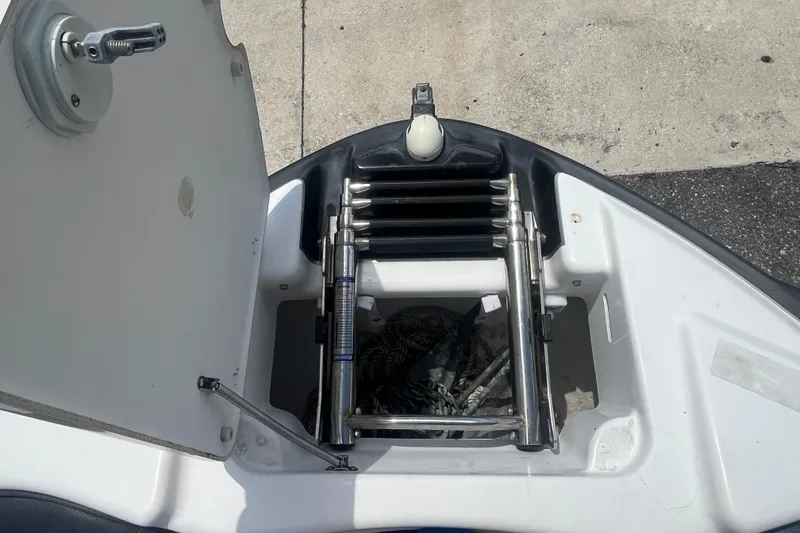 Slide: The Image of 2014 Yamaha AR240 HO boat anchor storage compartment with ladder. - 22