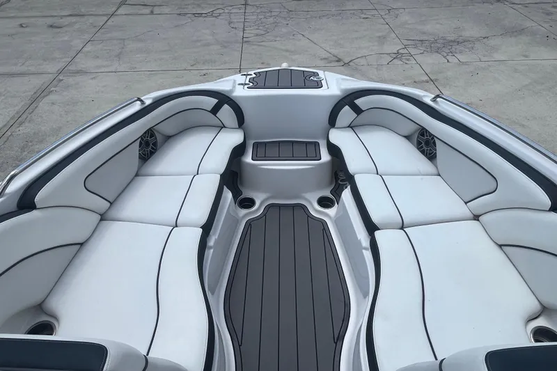 Slide: The Image of 2014 Yamaha Boats AR240 HO interior with white cushioned seating and sleek design. - 7