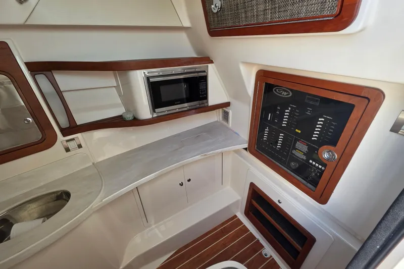 Slide: The Image of 2019 Grady-White Freedom 375 boat interior with control panel and microwave. - 25