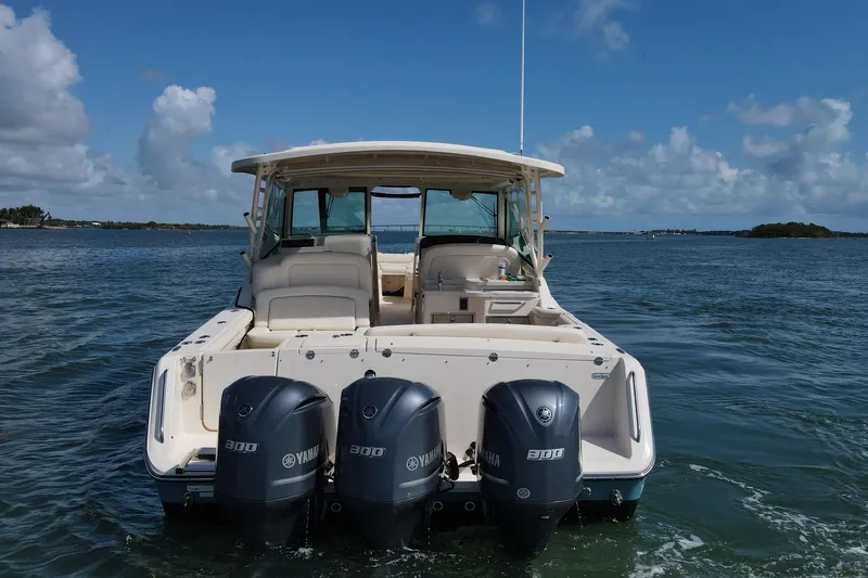 Slide: The Image of 2019 Grady-White Freedom 375 boat with triple Yamaha engines on open water. - 3