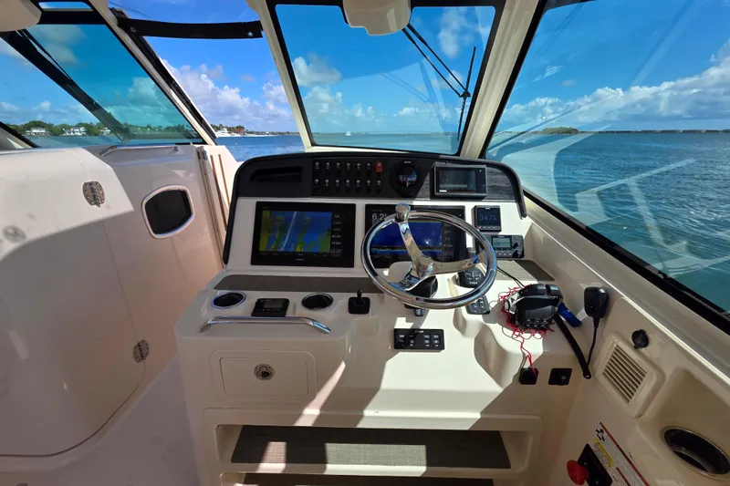 Slide: The Image of 2019 Grady-White Freedom 375 helm with navigation equipment and ocean view. - 17