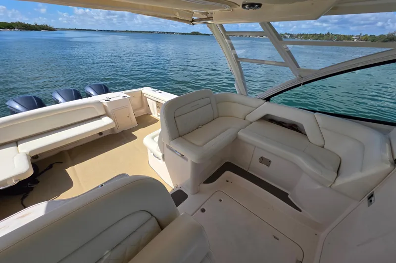 Slide: The Image of 2019 Grady-White Freedom 375 boat interior with luxurious seating on calm water. - 15