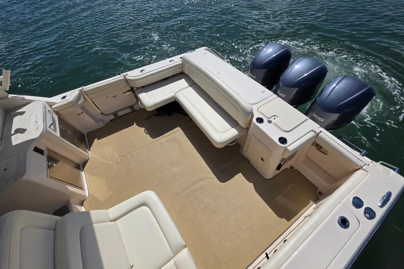 Slide: The Image of 2019 Grady-White Freedom 375 boat interior with triple outboard engines on water. - 11