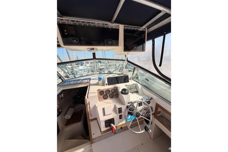 Slide: The Image of 1993 Grady-White Marlin 300 boat cockpit with steering wheel and instrument panel. - 20