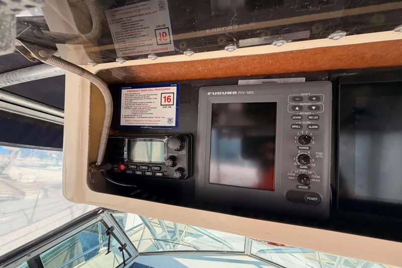 Slide: The Image of 1993 Grady-White Marlin 300 boat dashboard with Furuno FCV-582L and radio equipment. - 21