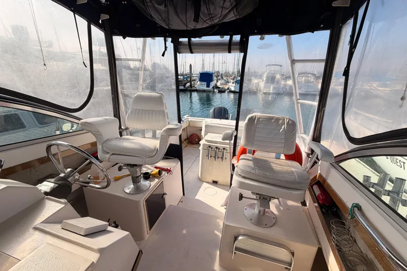 Slide: The Image of Interior of 1993 Grady-White Marlin 300 boat with helm and seating, docked at marina. - 35
