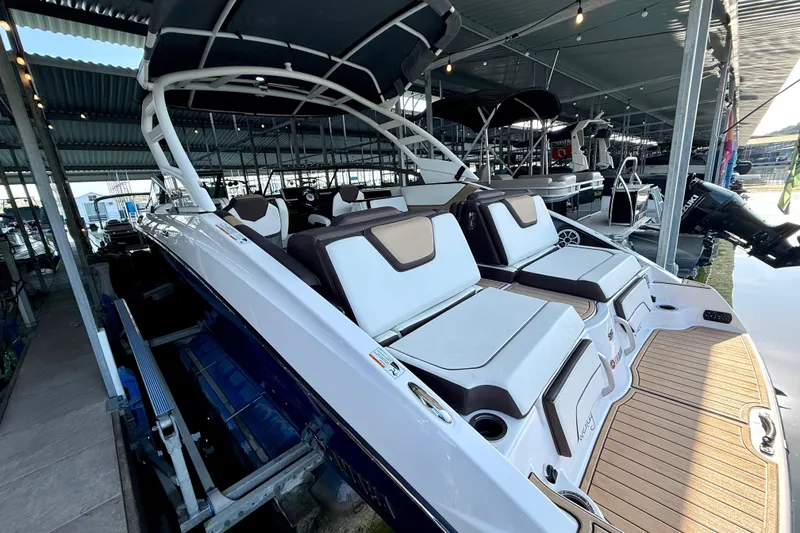 Slide: The Image of 2022 Yamaha Boats 252SD in marina, showcasing sleek design and spacious seating. - 11