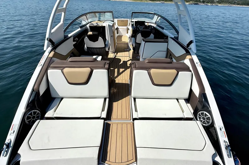 Slide: The Image of 2022 Yamaha Boats 252SD interior with luxurious seating on calm water. - 12