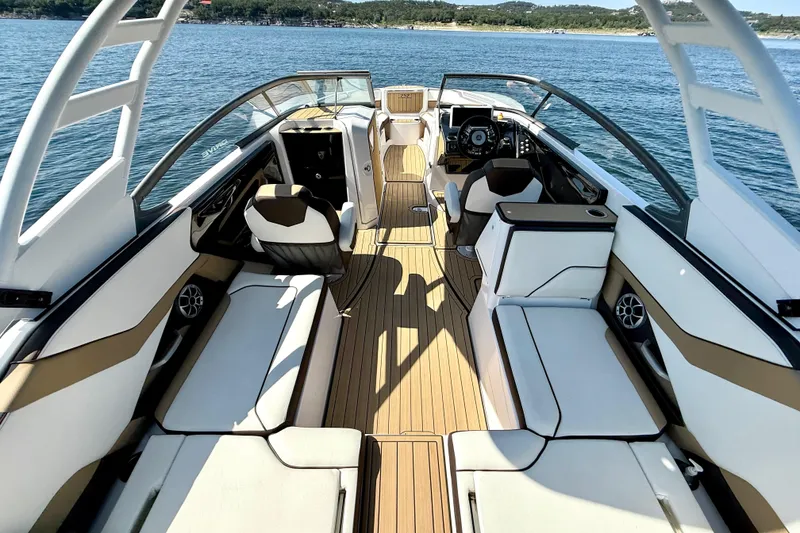 Slide: The Image of 2022 Yamaha Boats 252SD interior with luxurious seating and modern design on open water. - 13