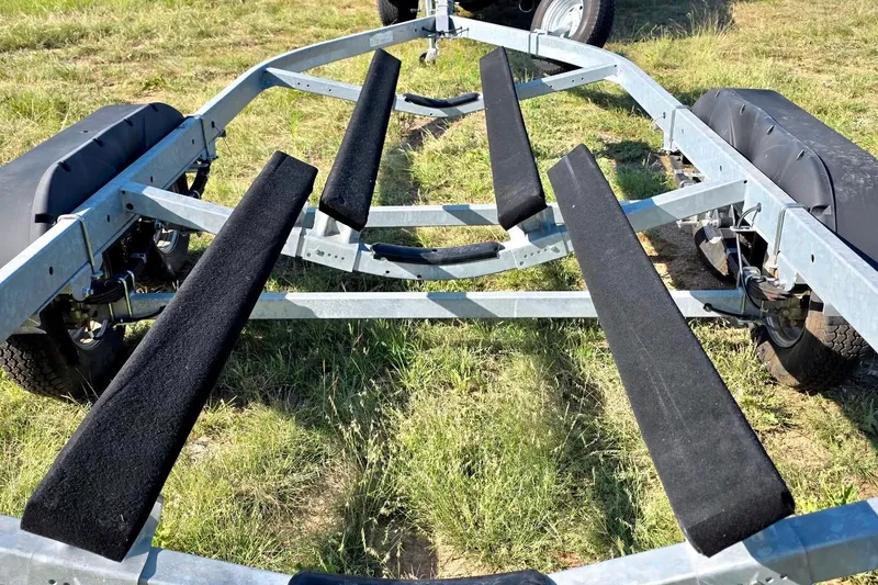 Slide: The Image of Boat trailer for 2022 Yamaha Boats 252SD on grassy field. - 27