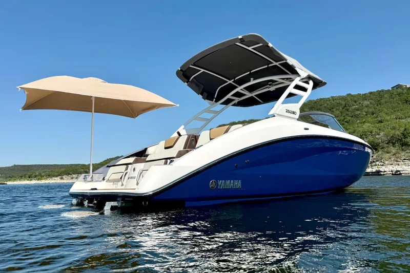 Slide: The Image of 2022 Yamaha Boats 252SD on water, featuring a sleek design and sunshade. - 3
