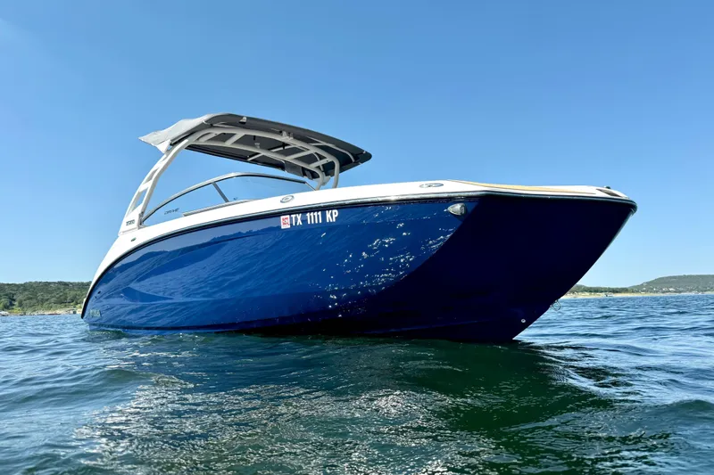 Slide: The Image of 2022 Yamaha Boats 252SD on water, showcasing sleek design and vibrant blue hull. - 5