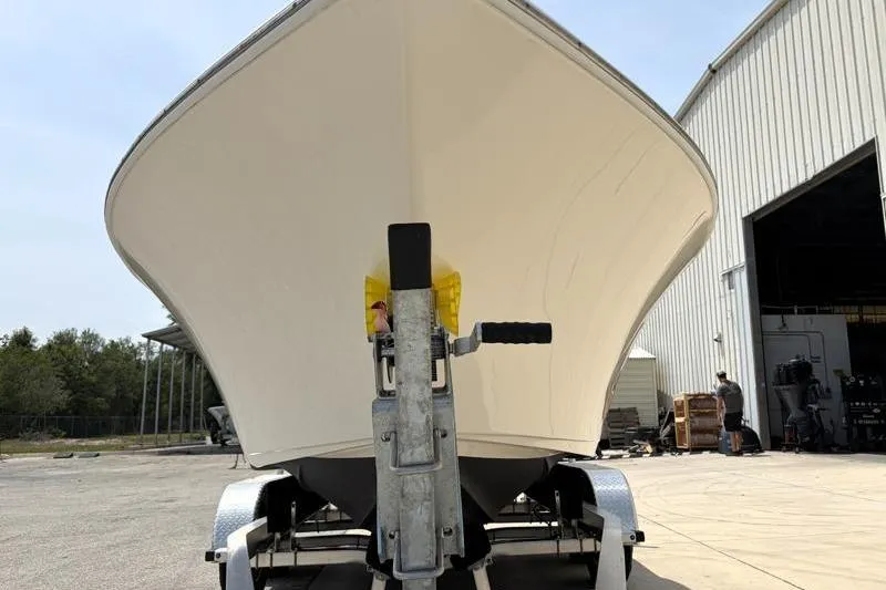 Slide: The Image of 2024 Key West 203 FS boat on trailer outside a warehouse. - 9