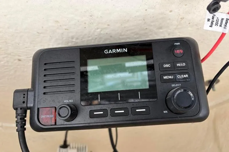 Slide: The Image of Garmin marine radio on 2024 Key West 203 FS boat dashboard, featuring distress button and controls. - 36