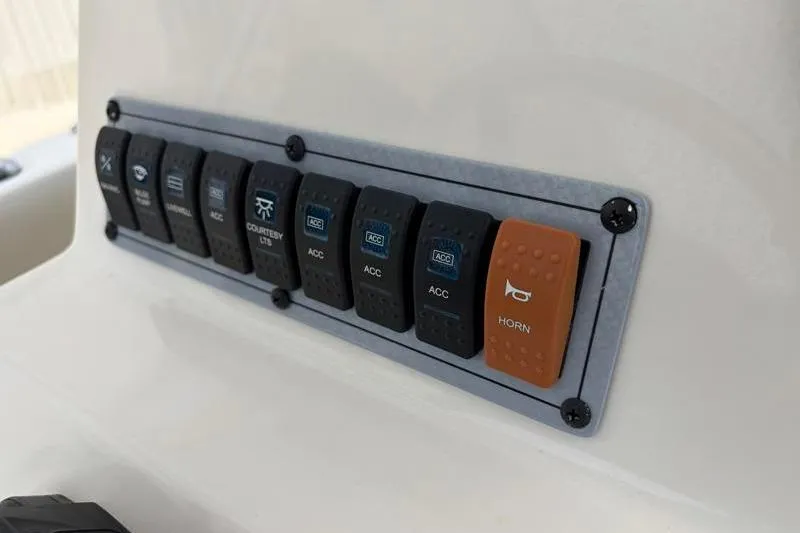 Slide: The Image of Control panel of 2024 Key West 203 FS boat with labeled switches. - 33