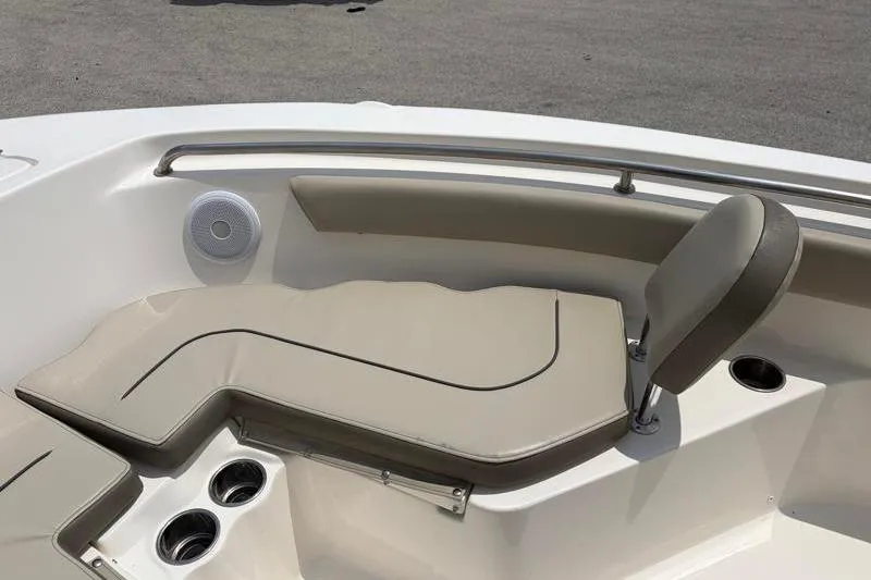 Slide: The Image of 2024 Key West 203 FS boat interior with cushioned seating and cup holders. - 21