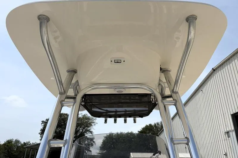 Slide: The Image of 2024 Key West 203 FS boat T-top with sturdy metal supports and clear sky background. - 25