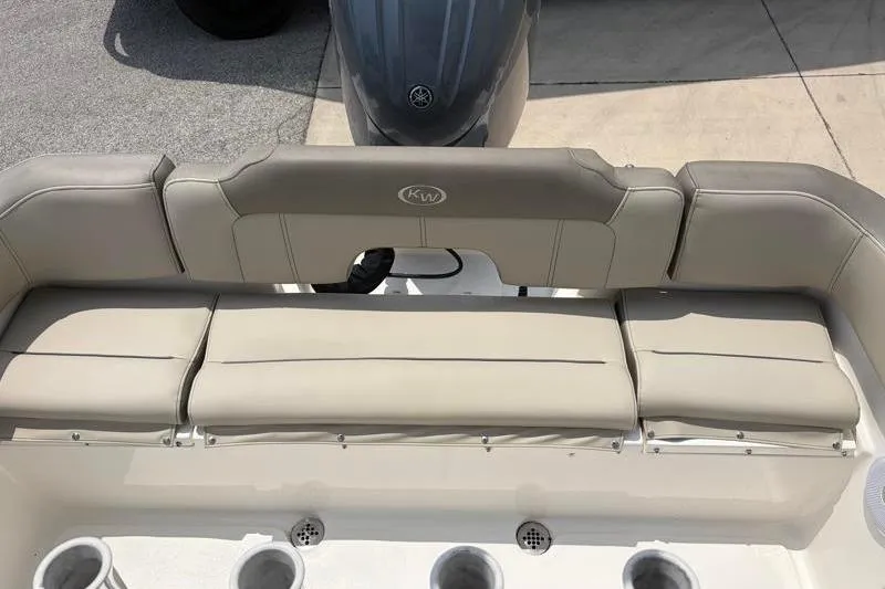 Slide: The Image of 2024 Key West 203 FS boat seating area with beige cushions and cup holders. - 38