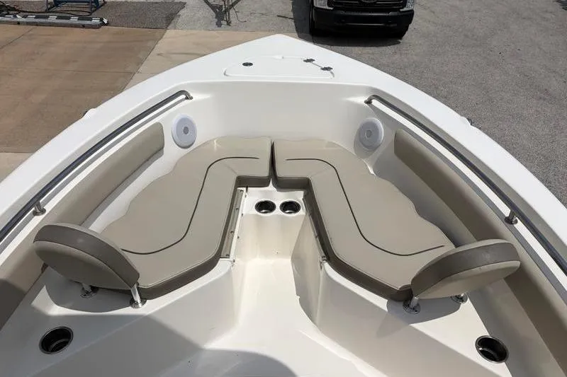 Slide: The Image of 2024 Key West 203 FS boat interior with cushioned seating and cup holders. - 20
