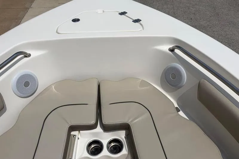 Slide: The Image of 2024 Key West 203 FS boat interior with cushioned seating and built-in speakers. - 23
