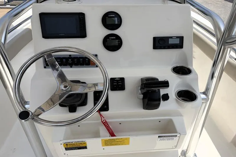 Slide: The Image of 2024 Key West 203 FS boat console with steering wheel, gauges, and controls. - 30