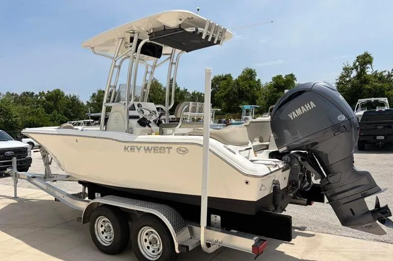 Slide: The Image of 2024 Key West 203 FS boat on trailer with Yamaha engine, parked outdoors. - 6