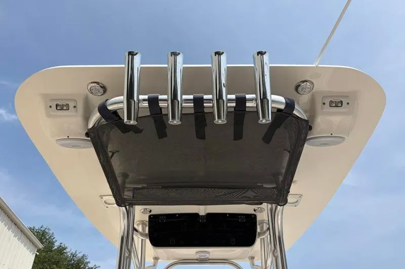 Slide: The Image of 2024 Key West 203 FS boat T-top with rod holders and speakers under a clear sky. - 39