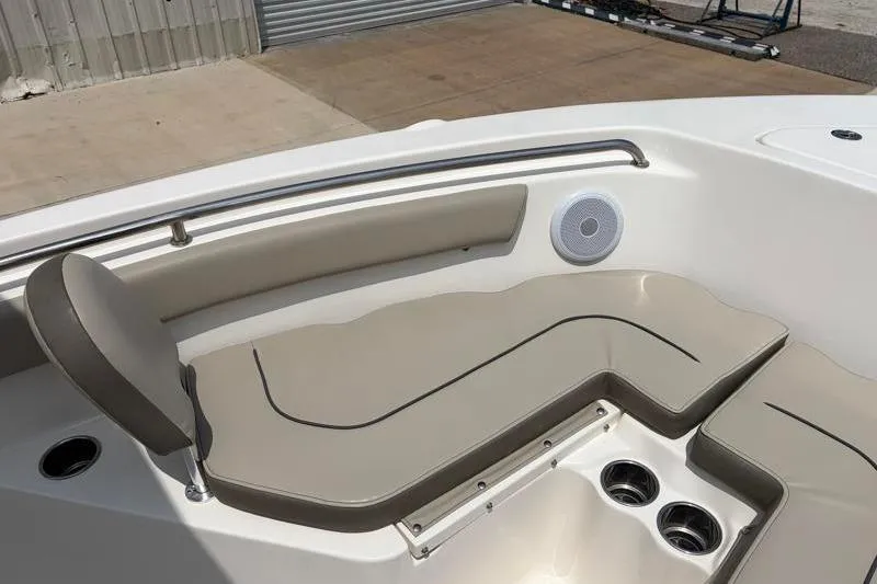 Slide: The Image of 2024 Key West 203 FS boat interior with cushioned seating and cup holders. - 22