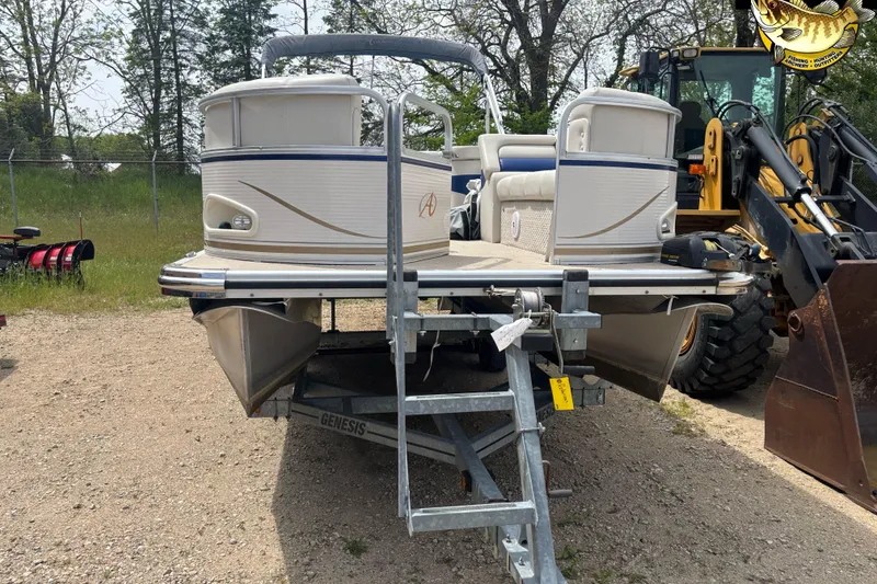 Slide: The Image of 2008 Avalon Paradise 20' pontoon boat on trailer, parked outdoors near construction equipment. - 4