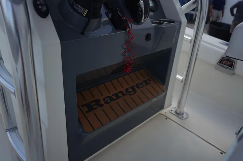 Slide: The Image of 2021 Ranger 2600 Bay boat console with branded mat and controls. - 10