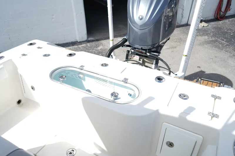 Slide: The Image of 2021 Ranger 2600 Bay boat with outboard motor and fishing rod holders. - 12