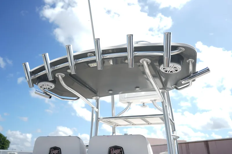 Slide: The Image of Ranger 2600 Bay 2021 boat with rod holders and speakers under a clear sky. - 13
