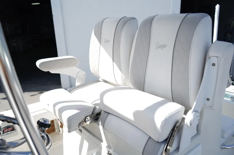 Slide: The Image of 2021 Ranger 2600 Bay boat seats with white upholstery and armrests. - 7