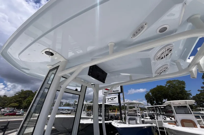 Slide: The Image of Tidewater 2300 Carolina Bay 2026 boat roof with speakers and sky view. - 15